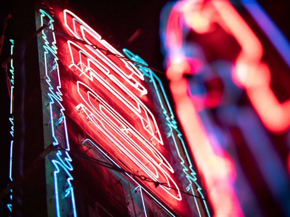 a close up of a neon sign on a building