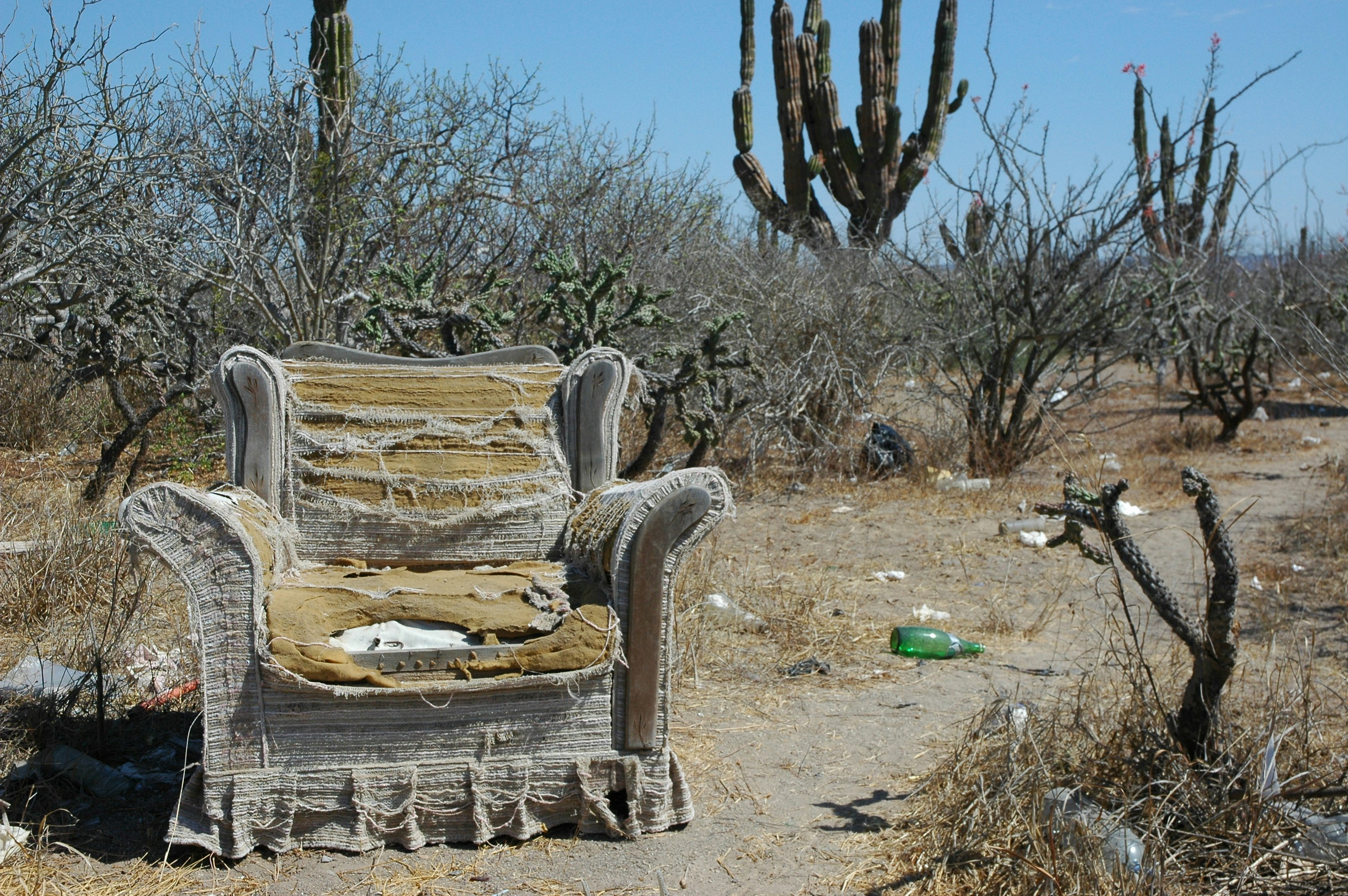 Armchair philosophy; All the comforts of home, roadside worship area, worn out armchair abandoned in the desert, near La Paz, Baja California Sur, Mexico