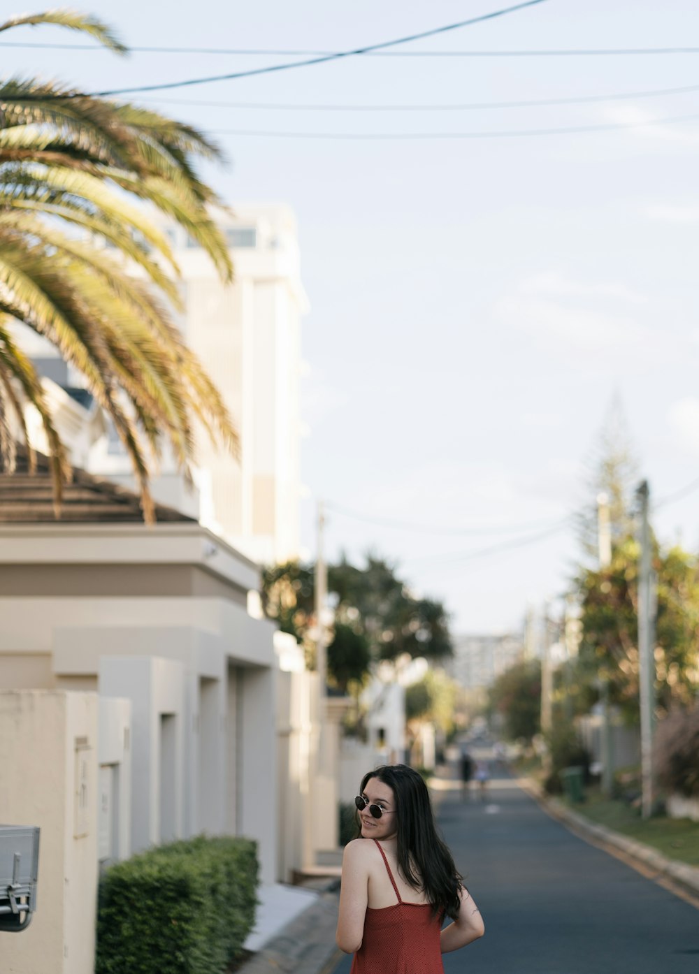 woman looking over her left shoulder near buildings