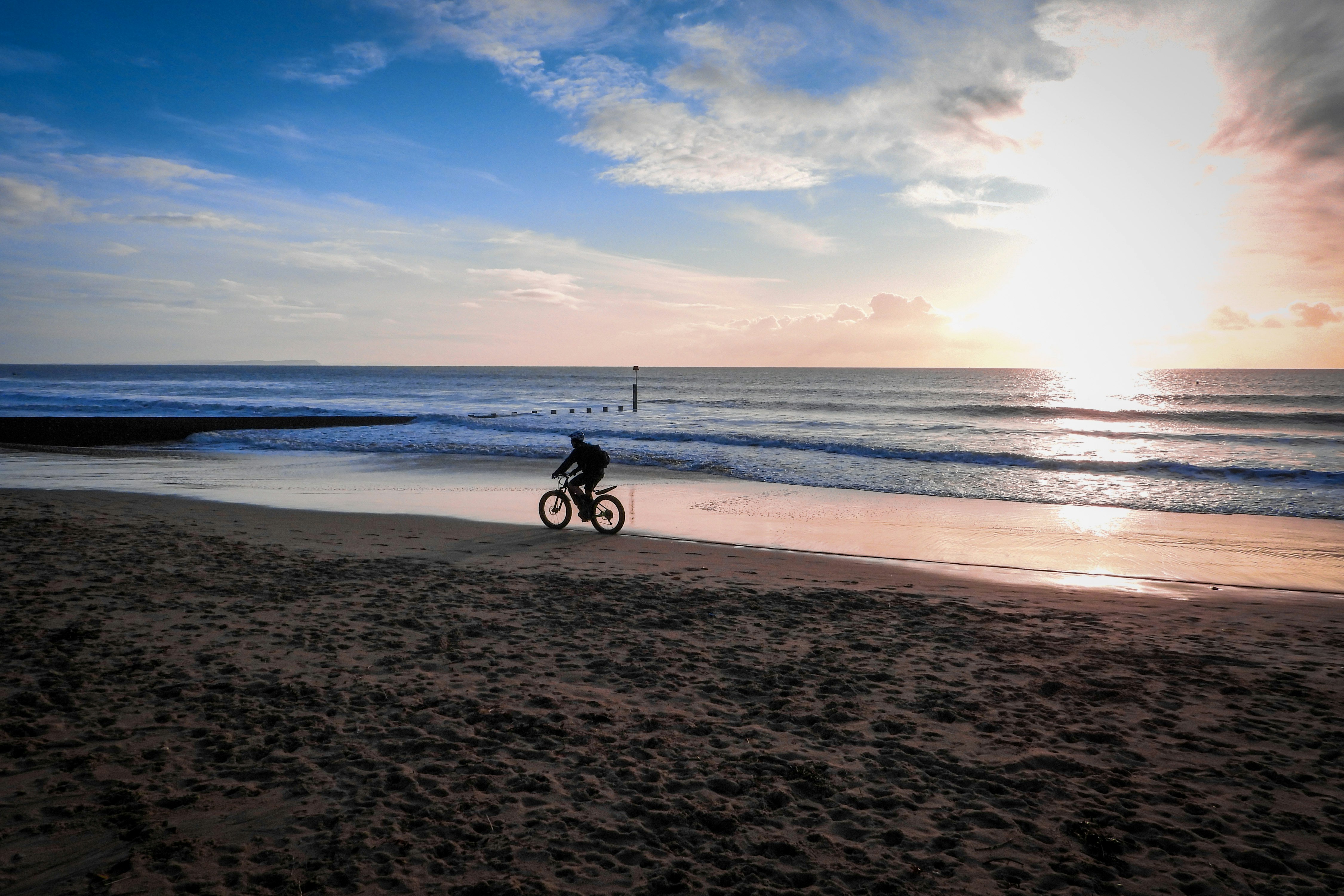 silhouette photo of person riding bicycle