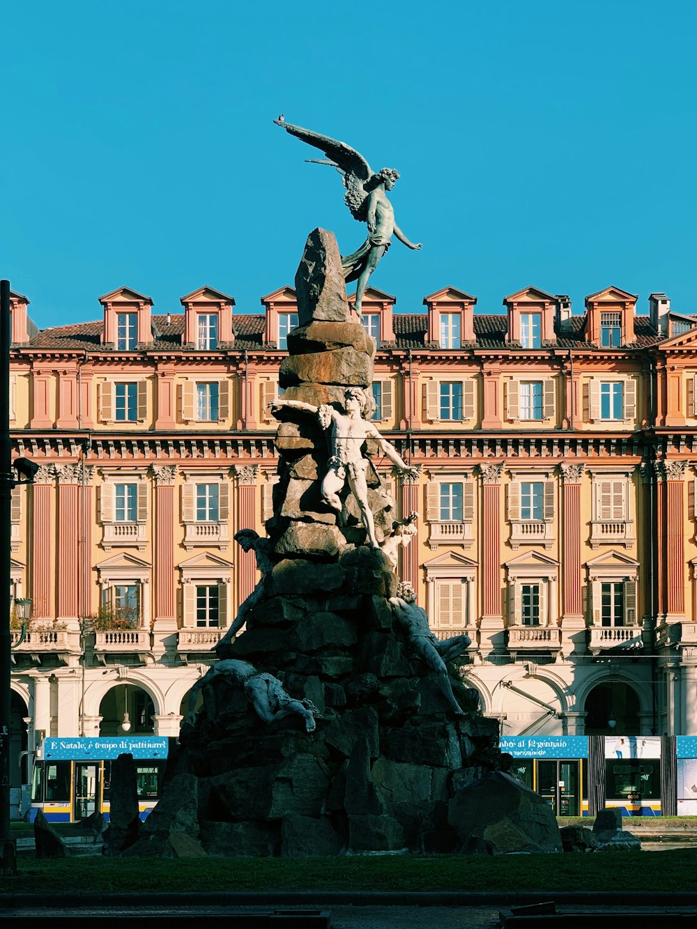 angel statue in front of brown building