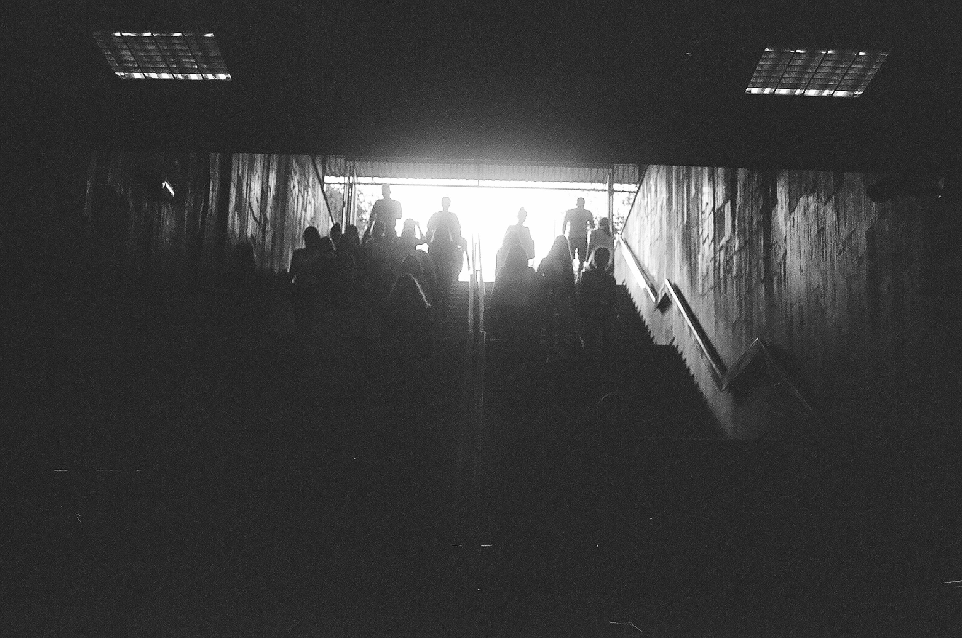 silhouette of walking people on stairs