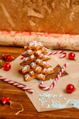 A festive display of beautifully decorated Christmas cookies stacked high.