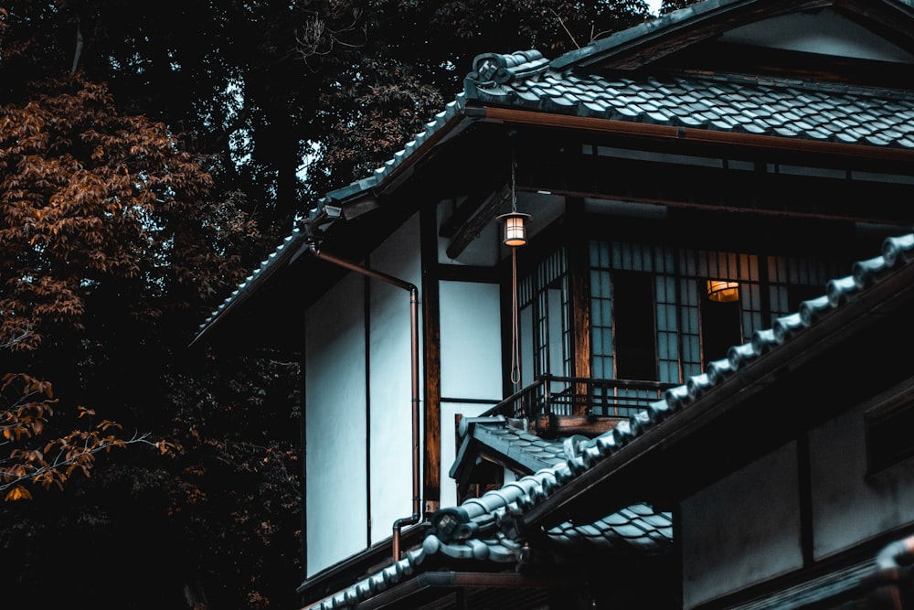 white and brown house beside tree