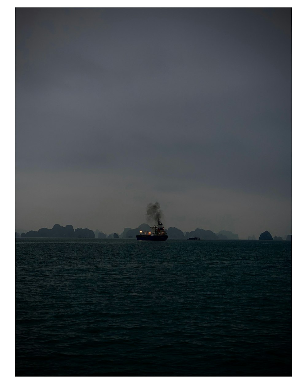 ship in sea under gray sky