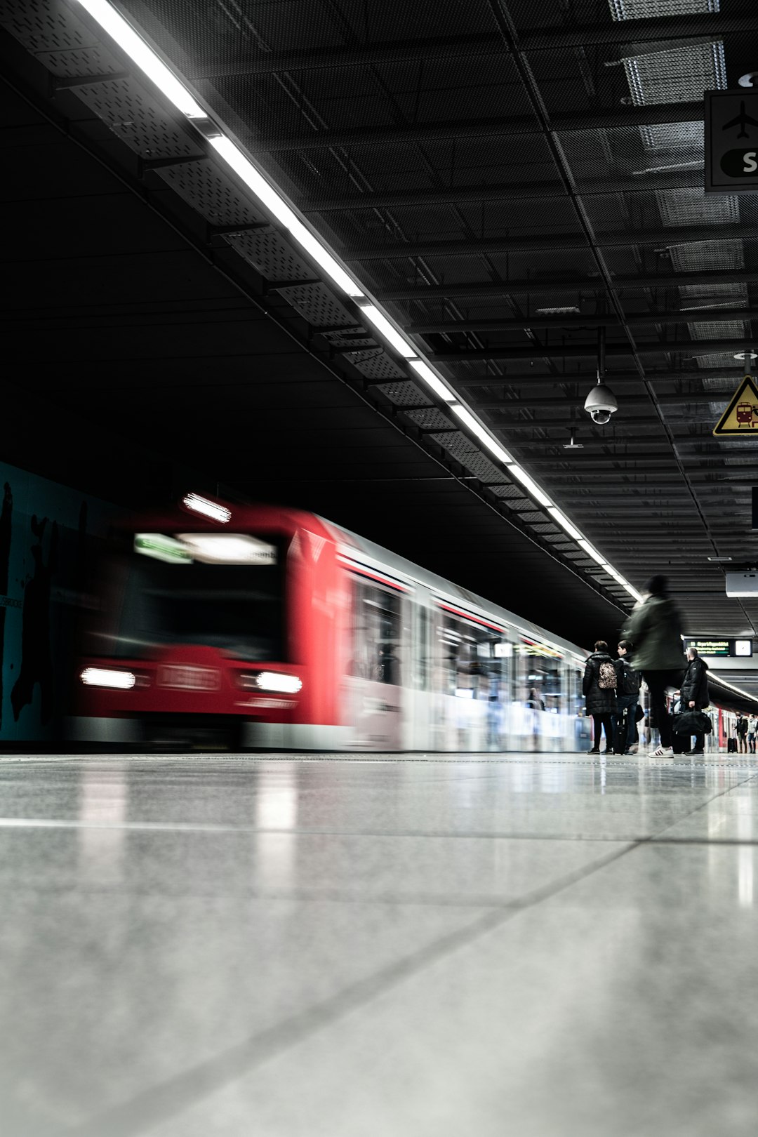 people standing at train station