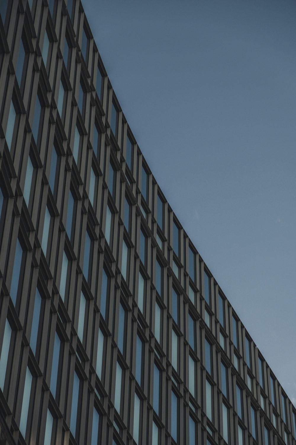 low-angle photo of building under gray sky