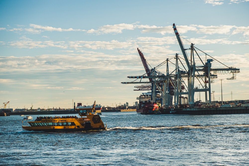 brown ship near tower cranes