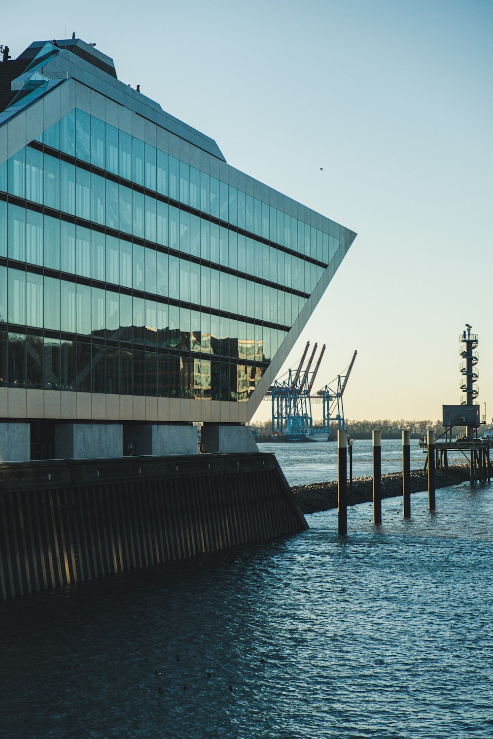 curtain wall building beside body of water