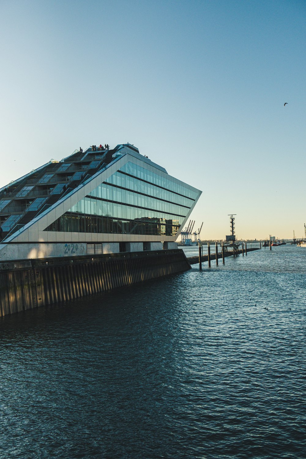 curtain wall building beside body of water