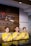 Three individuals are standing behind a reception desk, each wearing a yellow uniform. They are smiling and have their right hands placed over their chests. The background features a wooden wall with part of a logo and the word 'SEMARNG' visible.