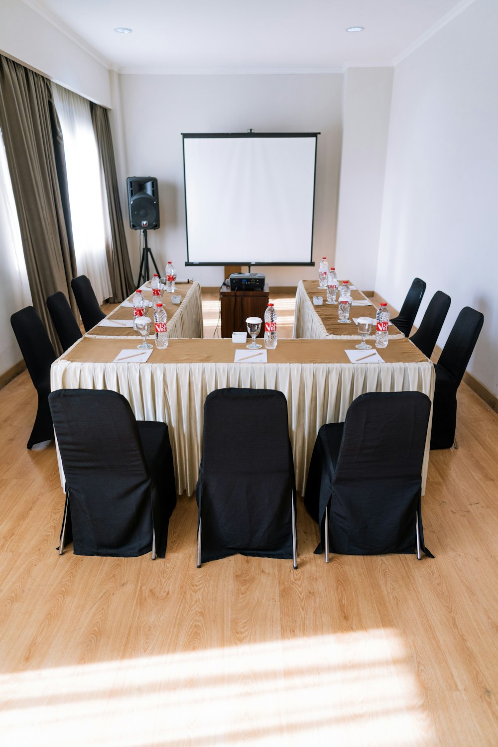 empty chairs inside room with projector canvas