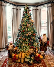 Christmas tree between Santa Claus dolls