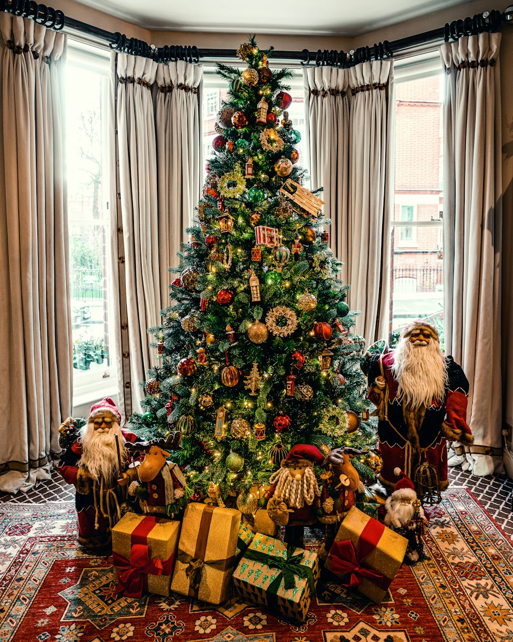 Christmas tree between Santa Claus dolls