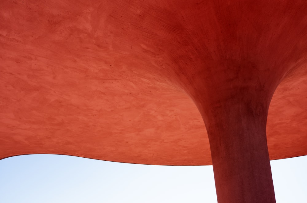 a large red structure with a sky in the background