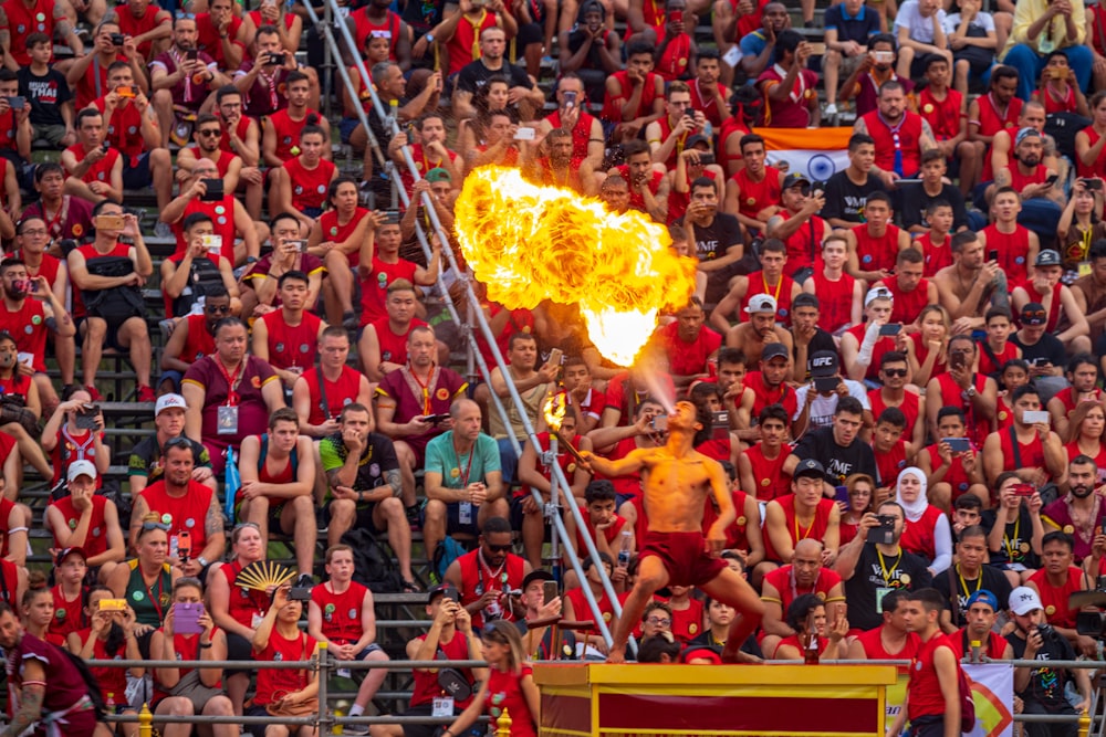 time-lapse photography of people watching a man blowing fire