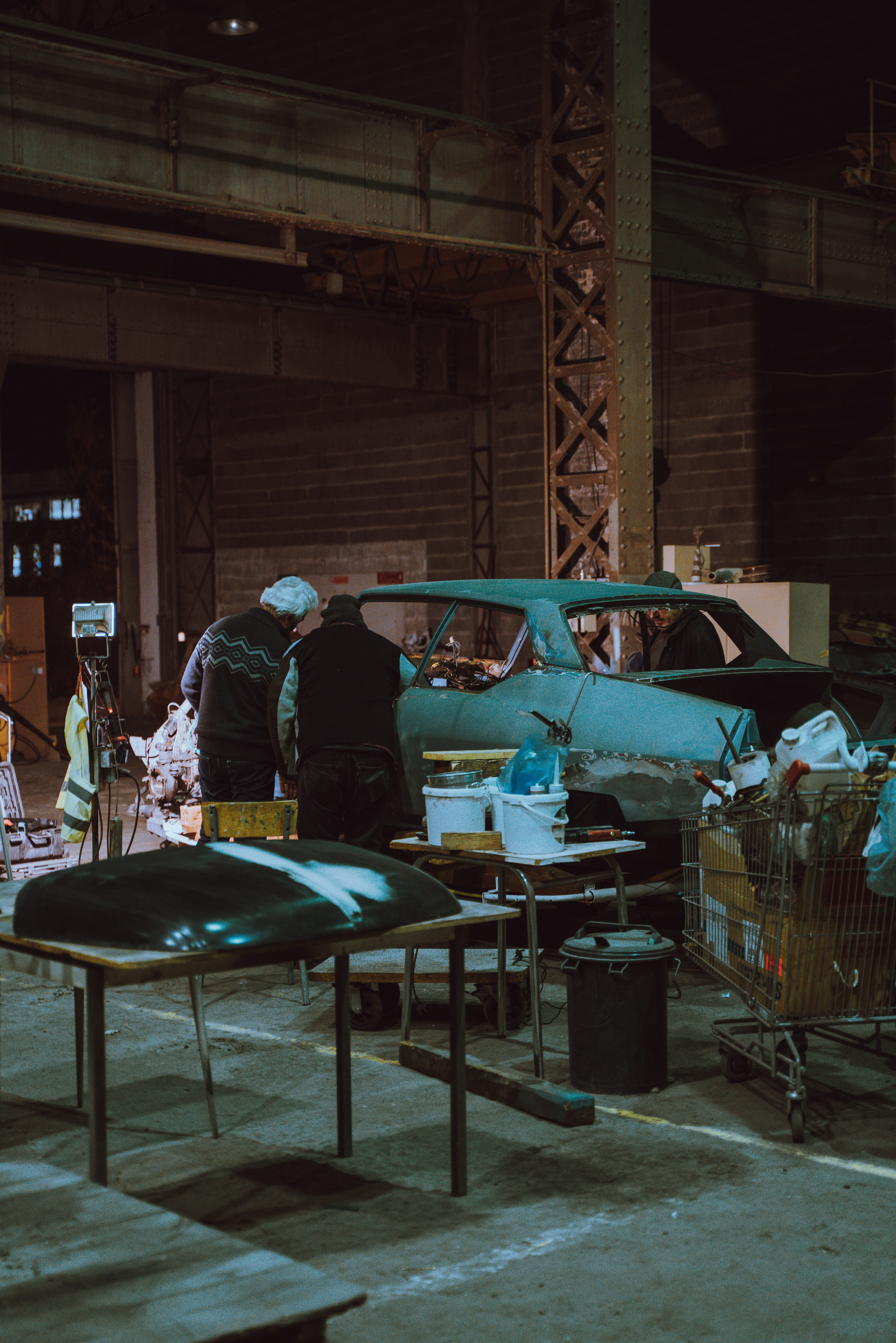 people beside unfinished car