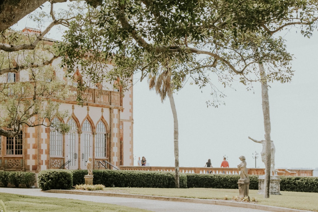 green trees beside brown building during daytime