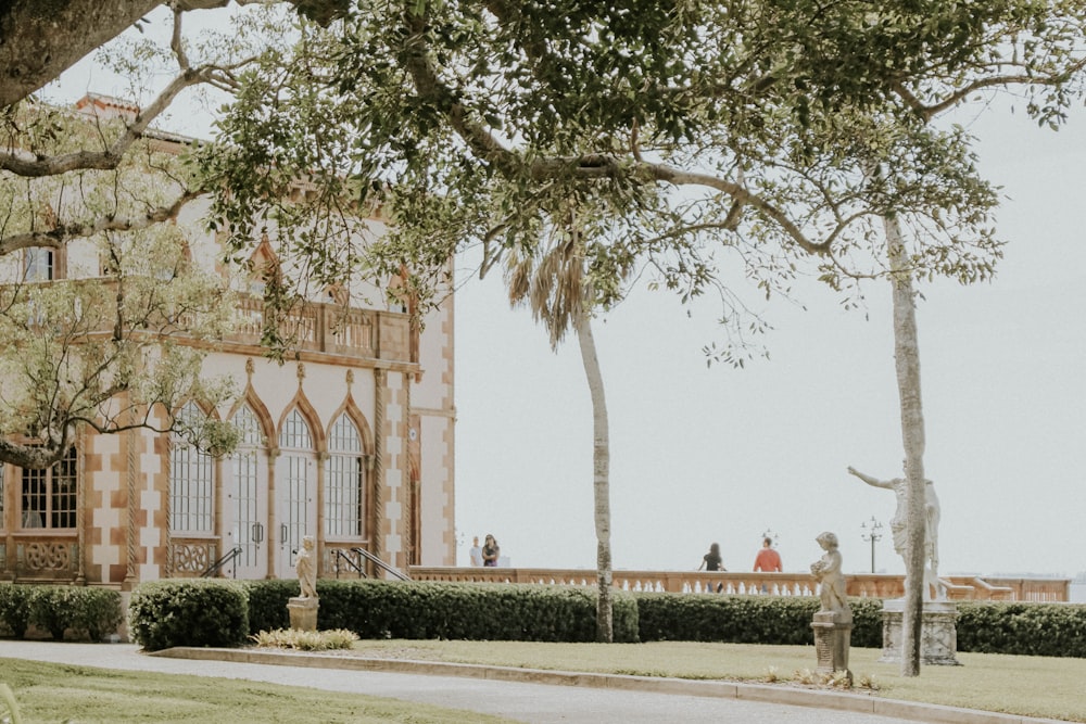 green trees beside brown building during daytime