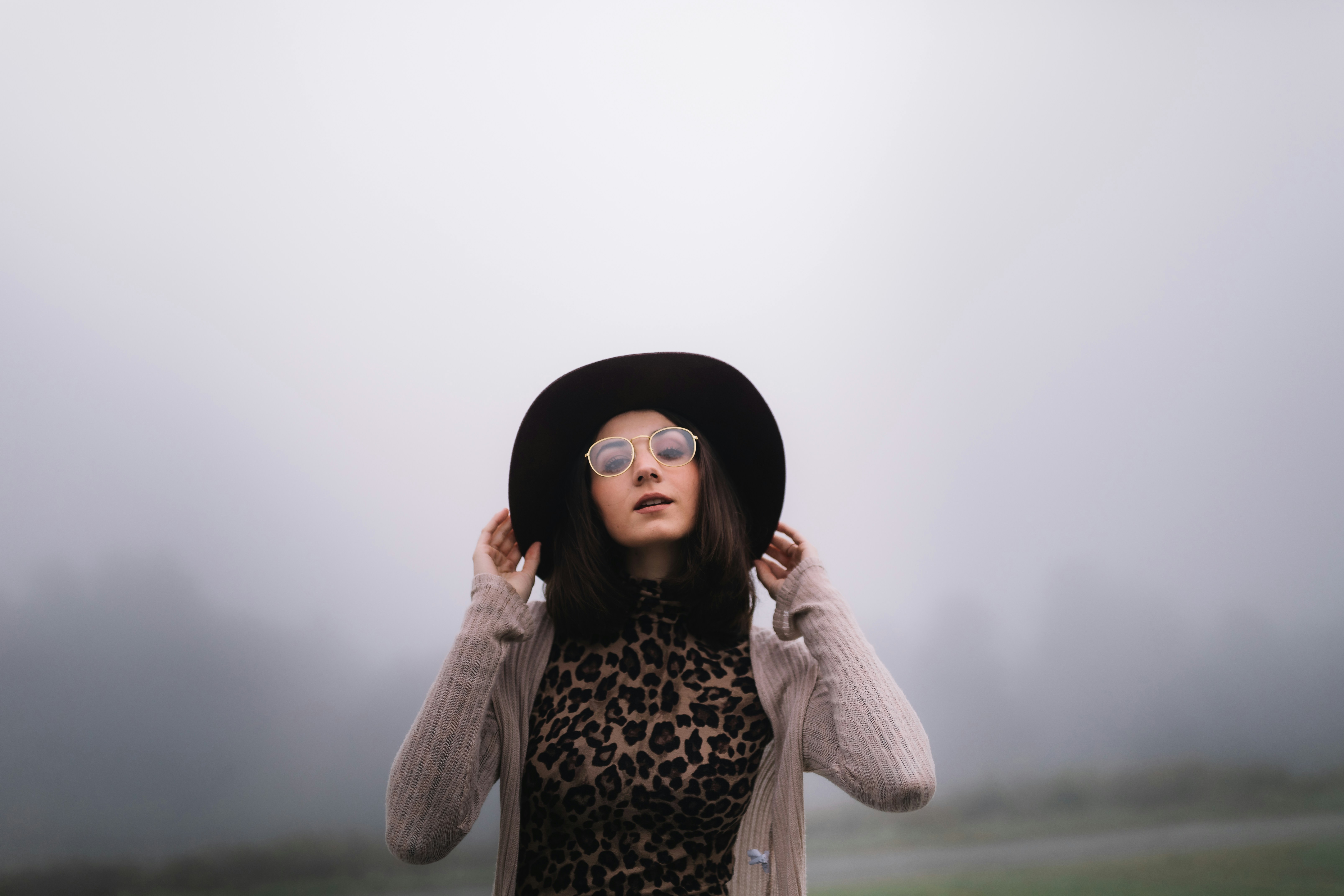 woman wearing black hat and brown cardigan