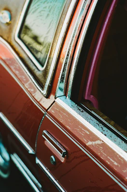 Before and after side-by-side of auto paint removal on a classic car door.