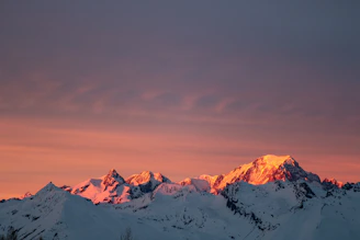 A warm sunset view of the Himachal mountains with travelers enjoying the serene landscape.