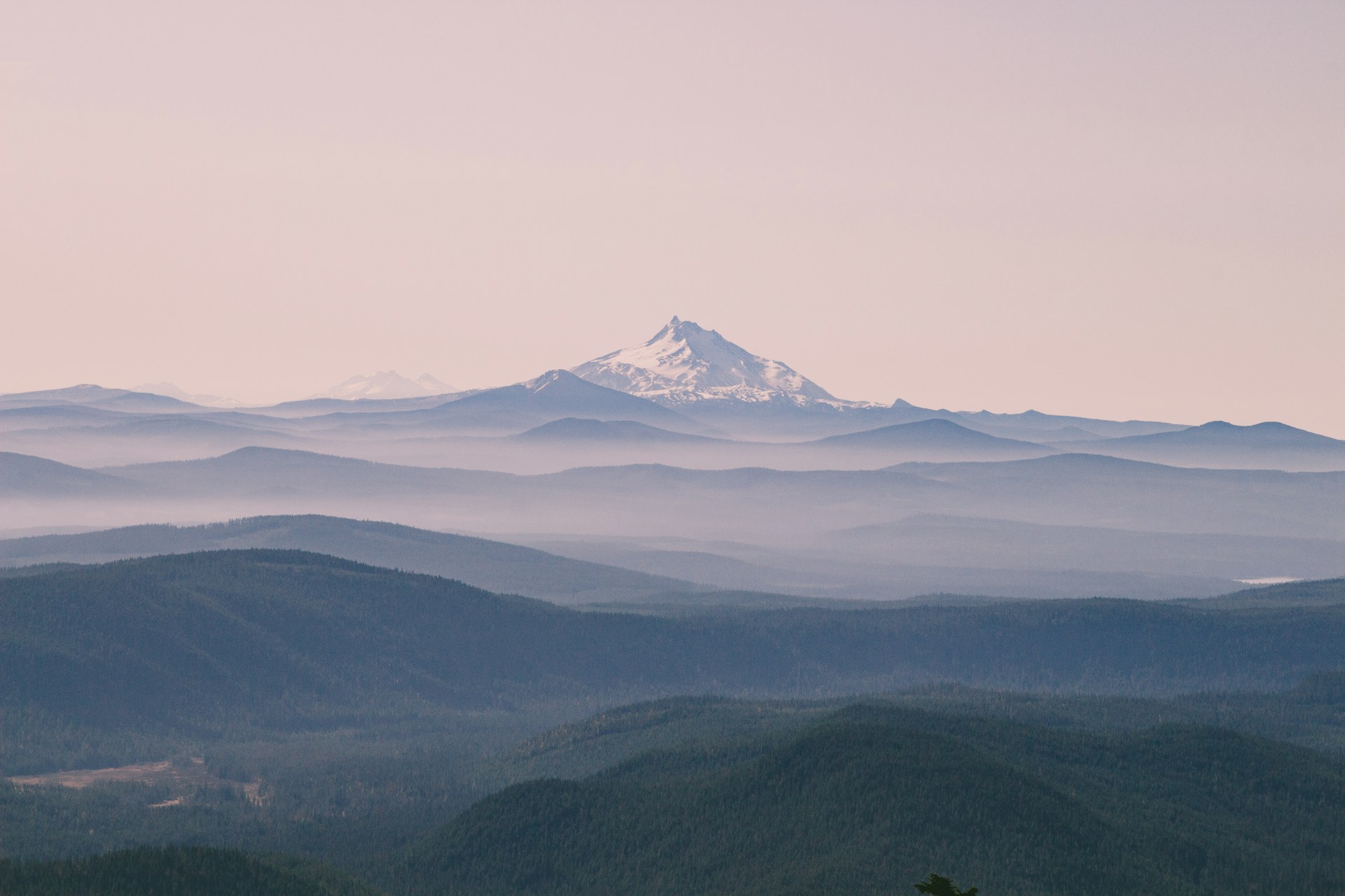 aerial photography of green field viewing summit of mountain