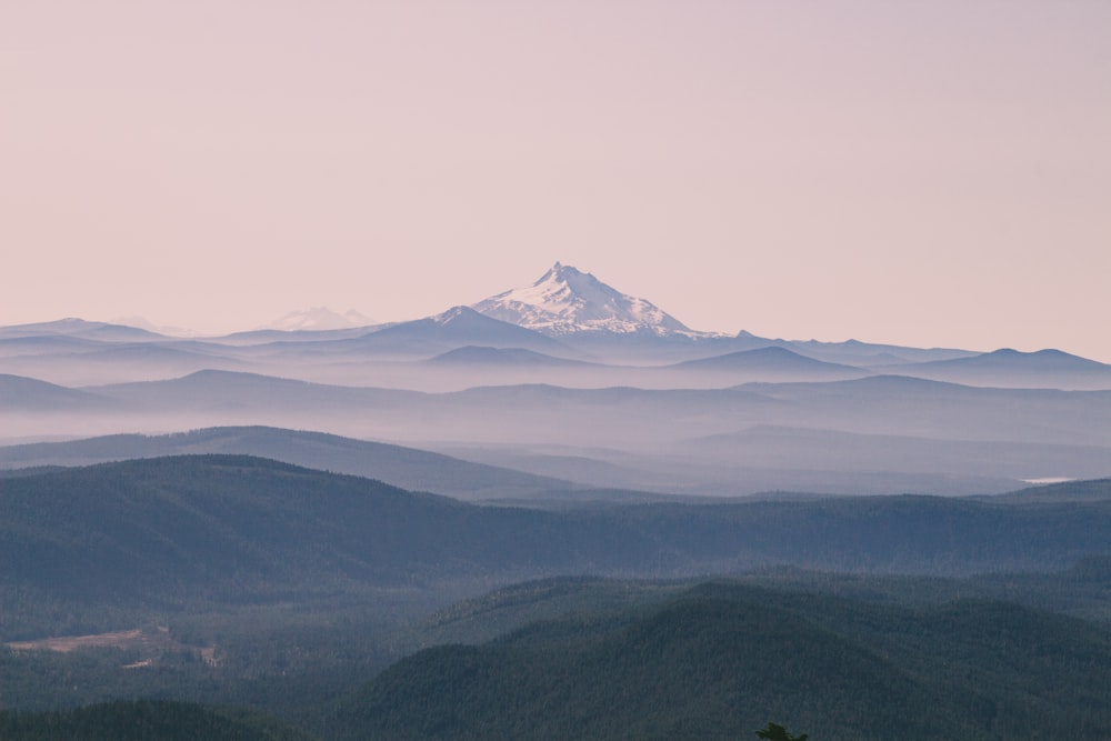 aerial photography of green field viewing summit of mountain