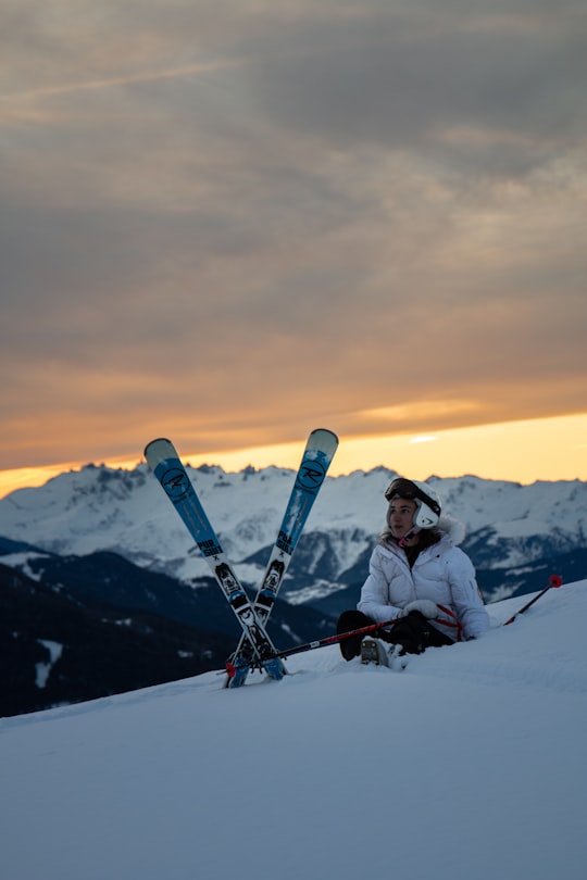 man sitting beside a snow ski blades in Peisey-Nancroix France