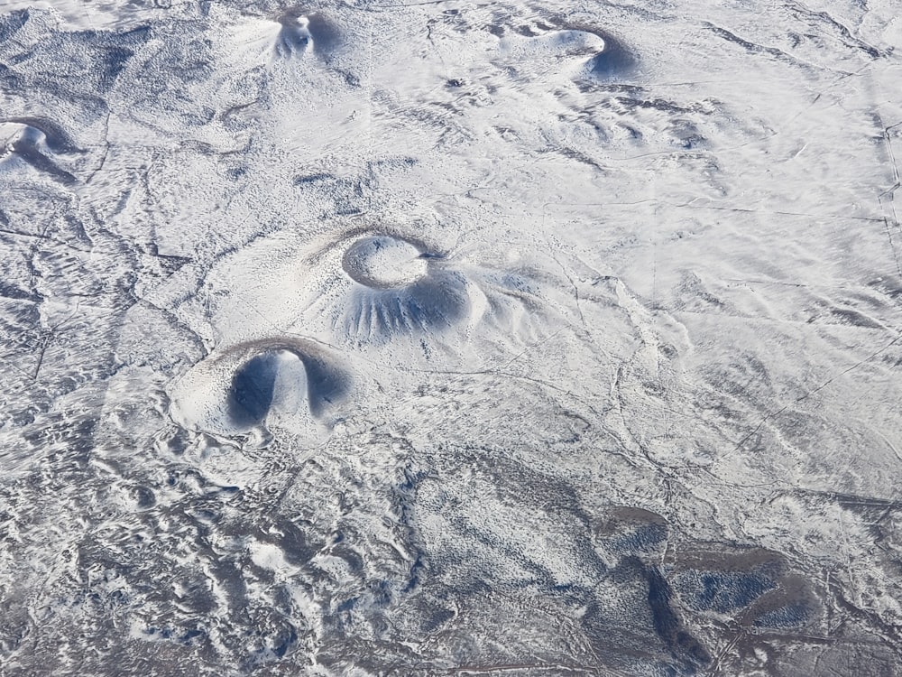 a snow covered landscape with footprints in the snow