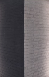 a clock on the side of a brick building