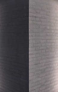 a clock on the side of a brick building