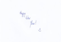 A handwritten message in blue ink stating 'Happy New Year!' with an accompanying smiley face at the bottom.