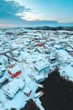 aerial photo of snow covered buildings during daytime