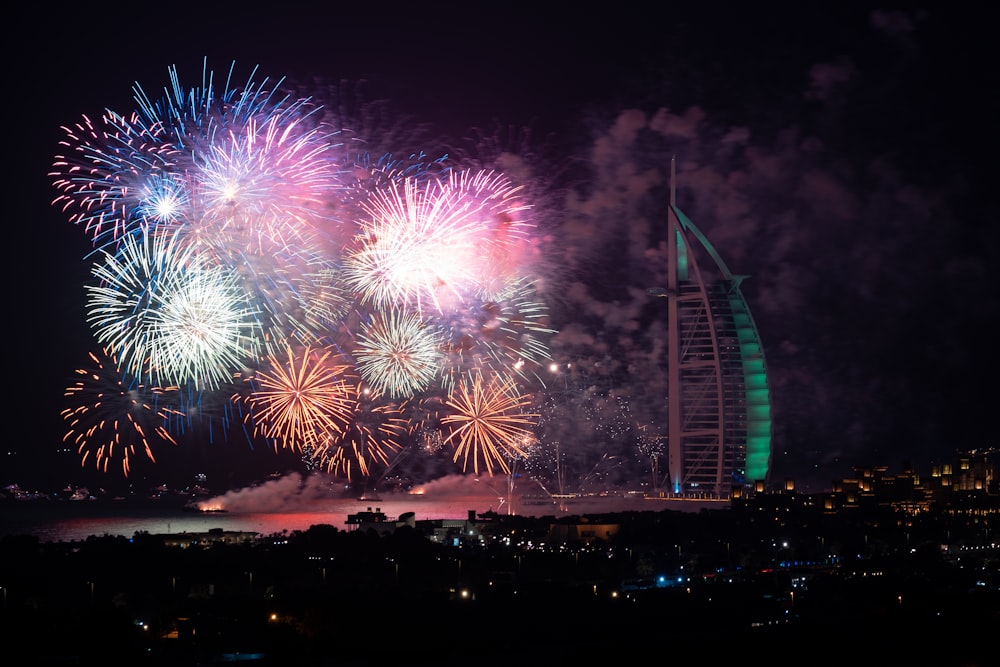Fireworks display near Burj Al Arab building at night time