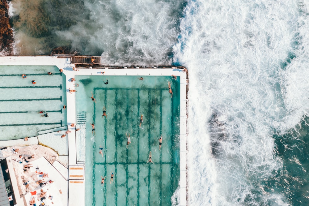 aerial photo of swimming pool near ocean durign daytime