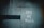 A weathered wall with a faded green texture features graffiti that reads 'PAY MY BILLS' in white paint. A dark horizontal line runs across the left side of the wall.