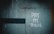 A weathered wall with a faded green texture features graffiti that reads 'PAY MY BILLS' in white paint. A dark horizontal line runs across the left side of the wall.