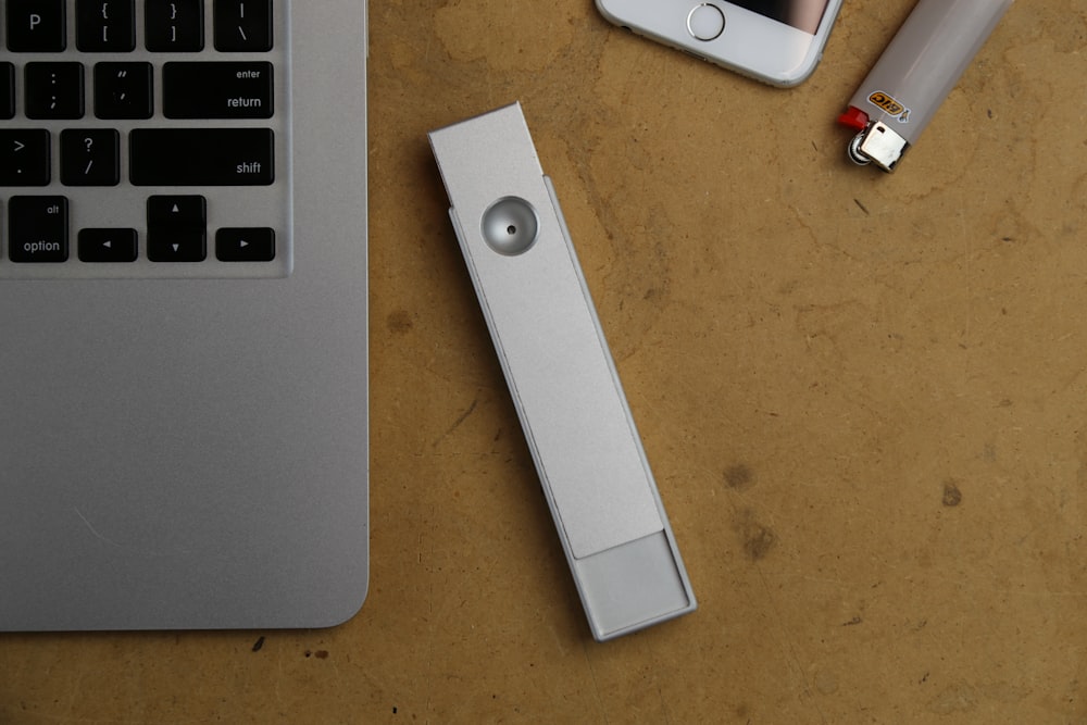 white USB flash driver beside MacBook