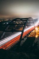time-lapse photography of vehicles passing by a bridge during nighttime