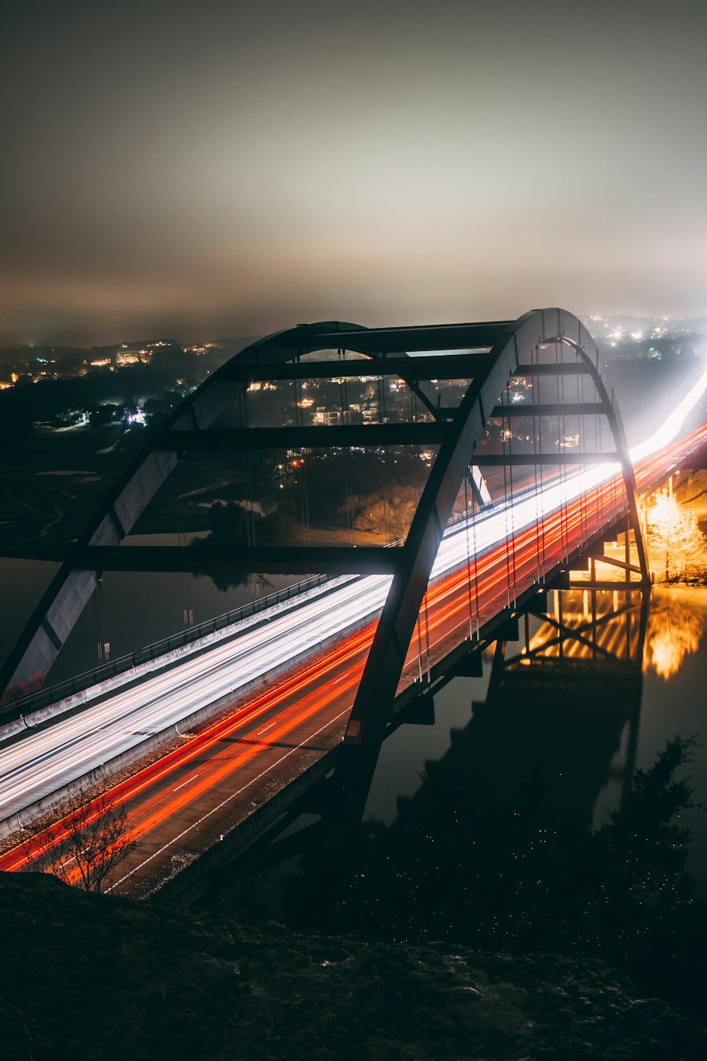 time-lapse photography of vehicles passing by a bridge during nighttime