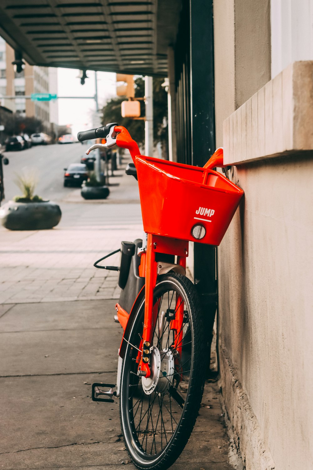 shallow focus photo of red and black bike parked beside sidewalk
