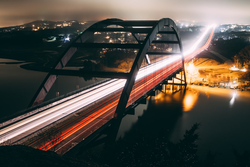 time-lapse photography of cars passing a bridge
