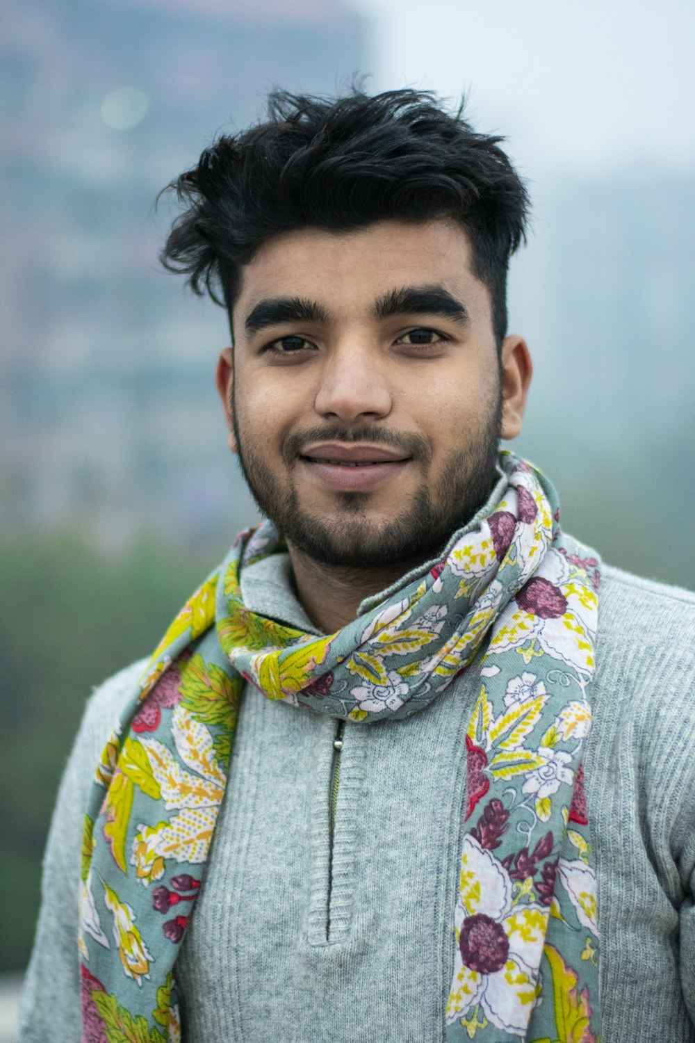 man wearing blue and yellow floral scarf