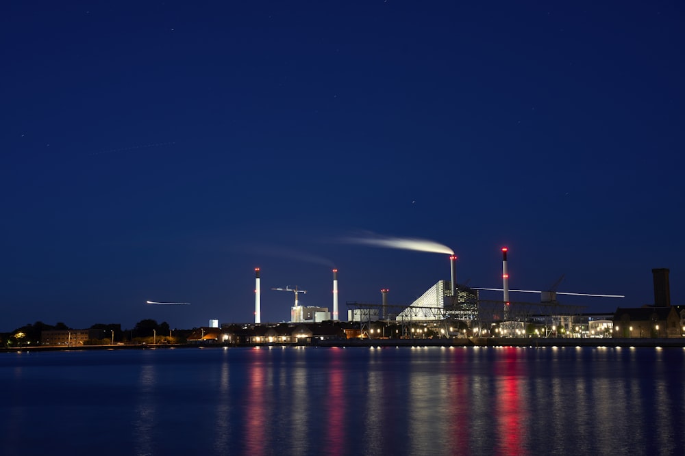 city buildings beside calm body of water during nighttime