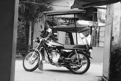 A sleek, modern sidecar attached to a vintage motorcycle, shot outdoors with natural light highlighting its craftsmanship.