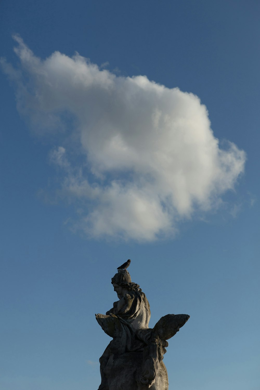 man riding horse statue under white and blue sky