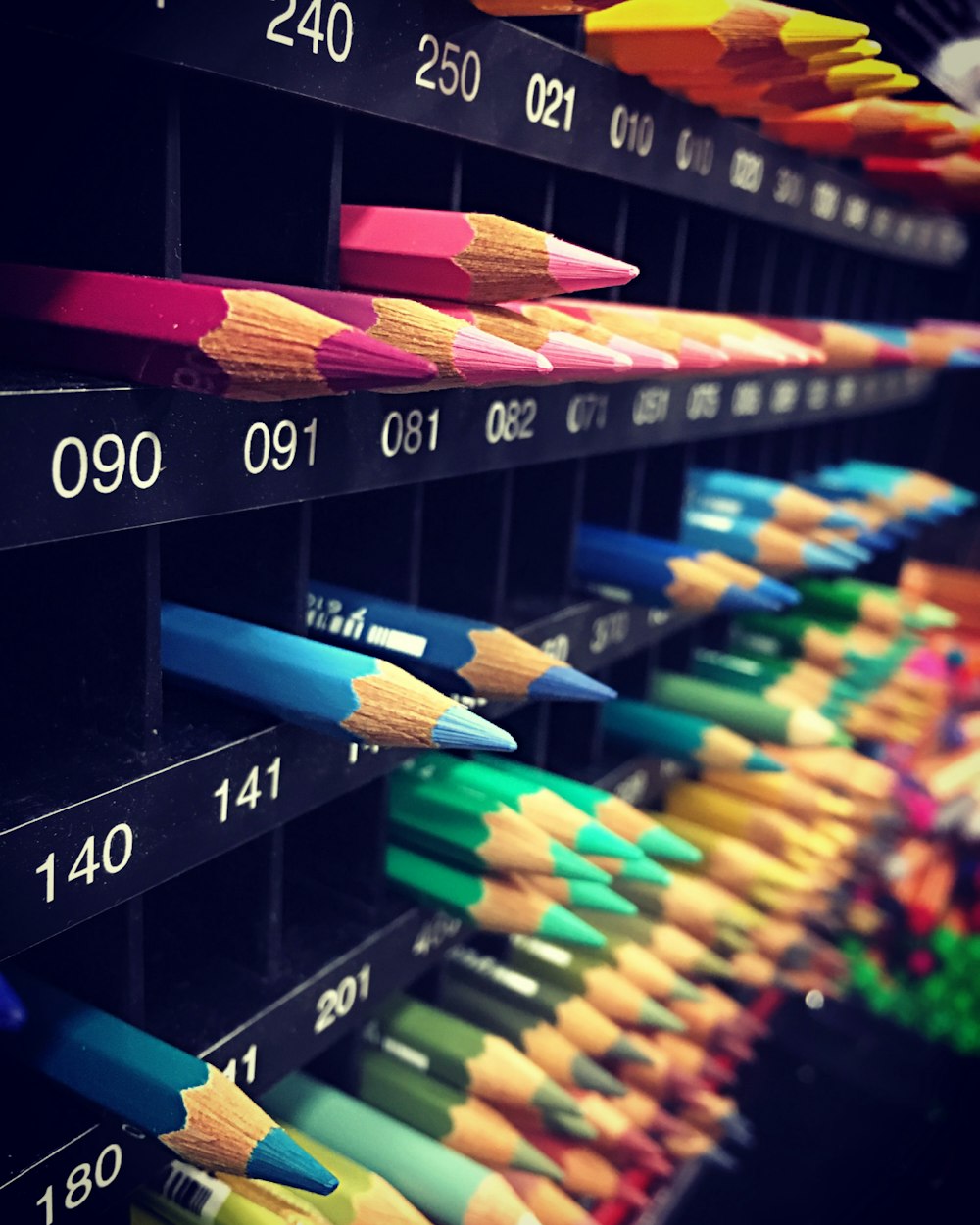assorted-color pencils in organizers