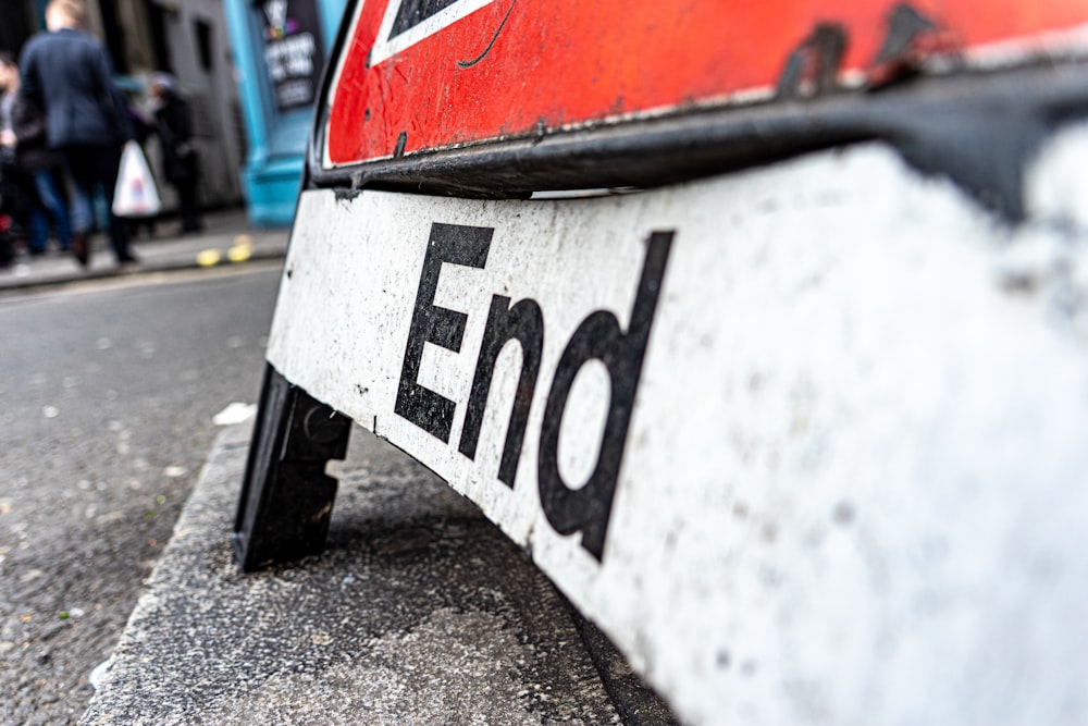 signage on concrete road near people