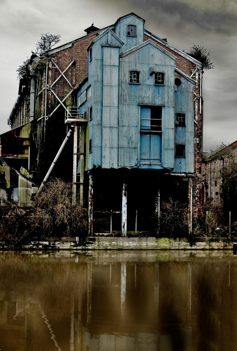 a large blue building sitting next to a body of water